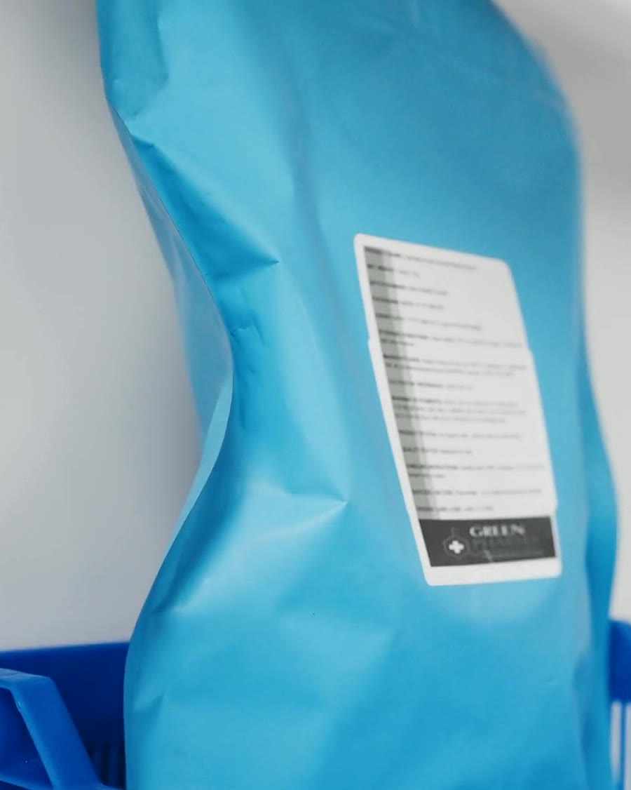 A sealed blue bag of material carrying a printed batch label